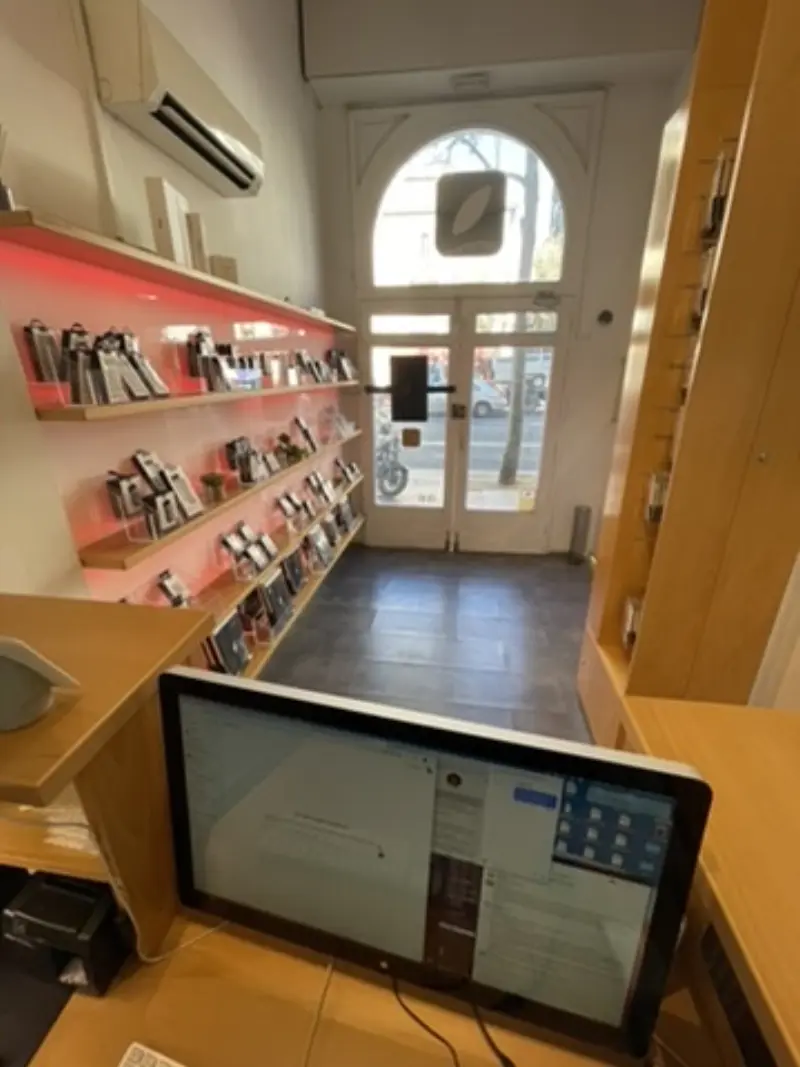 Jinank counter from employee POV — iMac with Airtable open, appointments scheduled