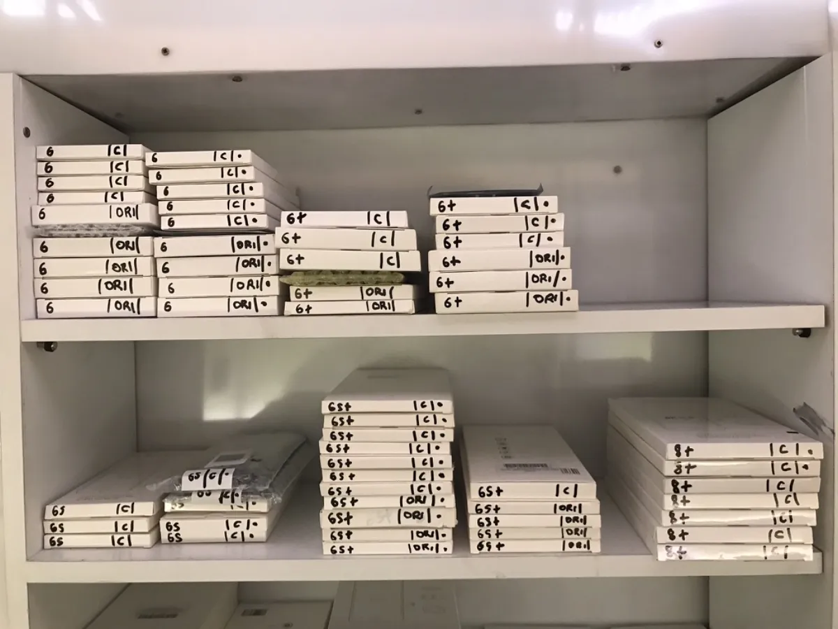 iPhone screens organized by model on shelf